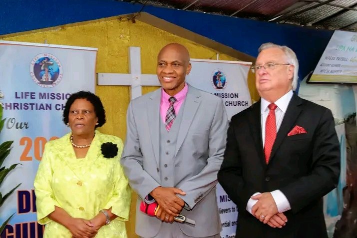 Bishop John Kaberere with his wife and a friend of the church